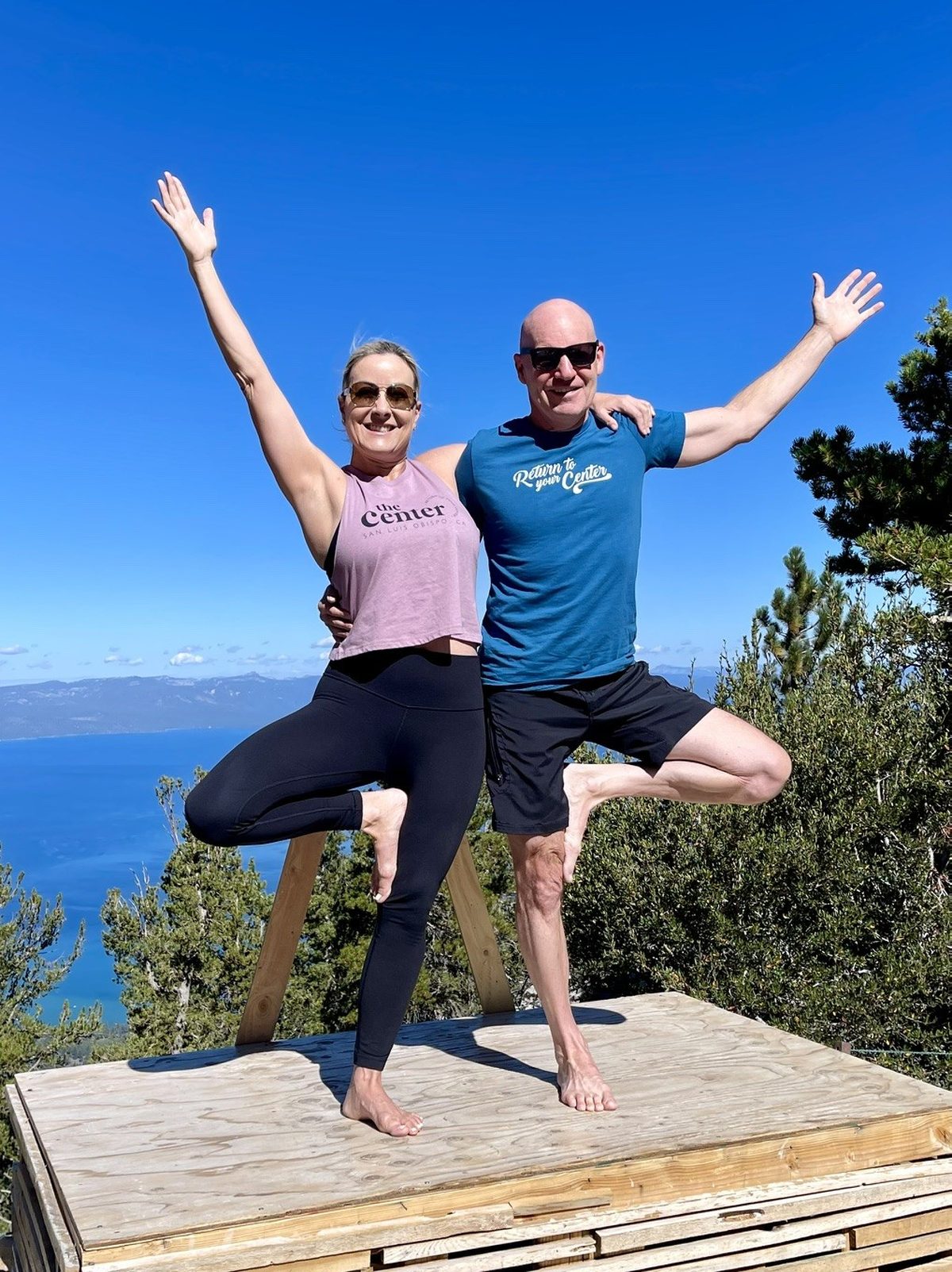 Dyna Boen and her partner Darin practicing yoga overlooking Lake Tahoe
